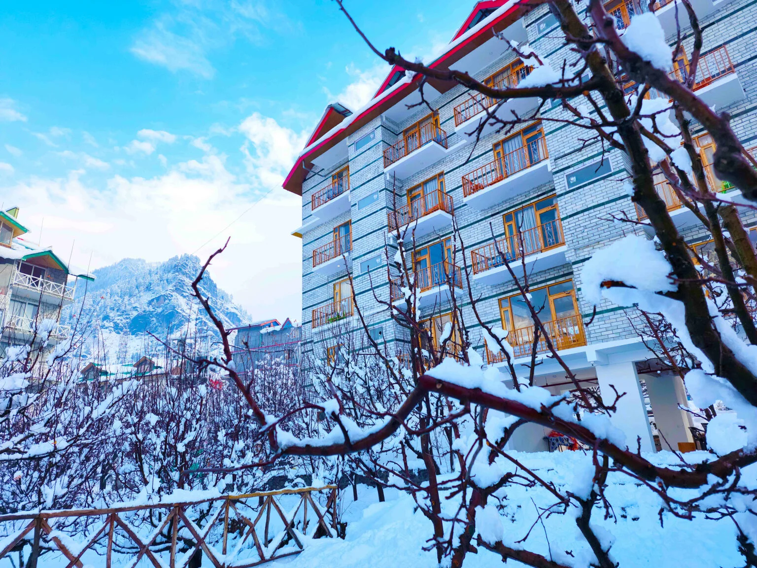 Marina Heights Hotel Exterior with Snow and Himalayas in Prini Manali